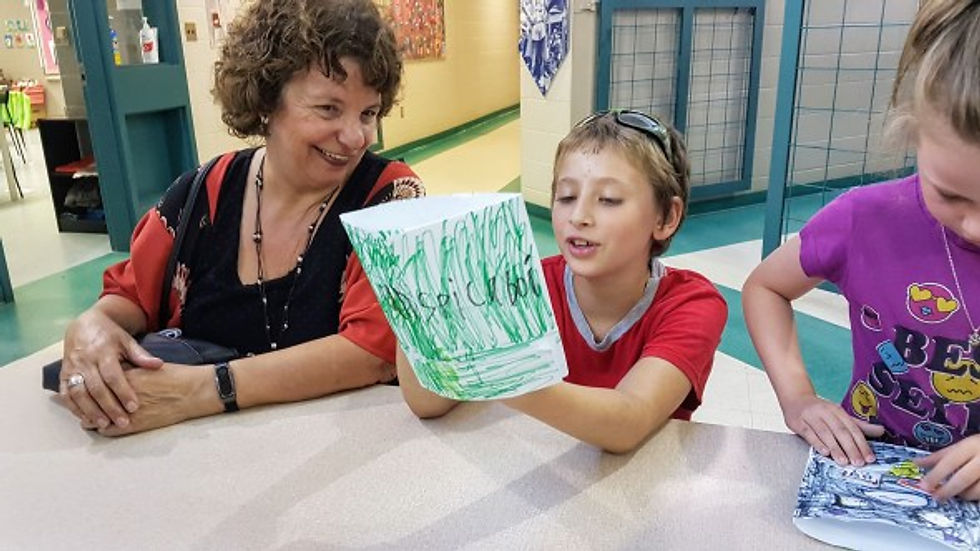 Beth Kelly Hatt, founder of Aquila Tours and a member of the Million Dollar Pledge, with Milltown Elementary School student Darius Davidson.